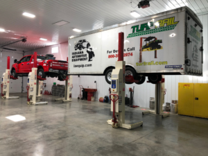Stertil-Koni mobile columns lifting a pickup truck and trailer